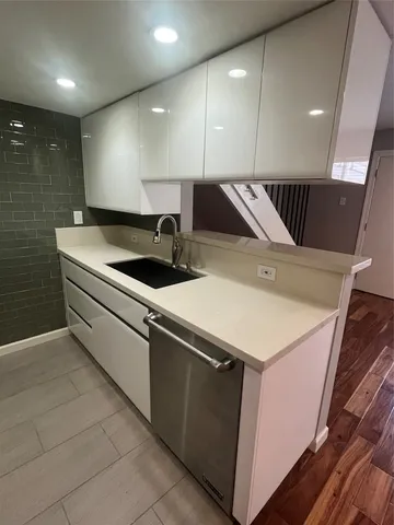a kitchen with a sink and a refrigerator