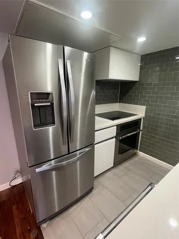 a kitchen with stainless steel appliances a refrigerator and a counter top