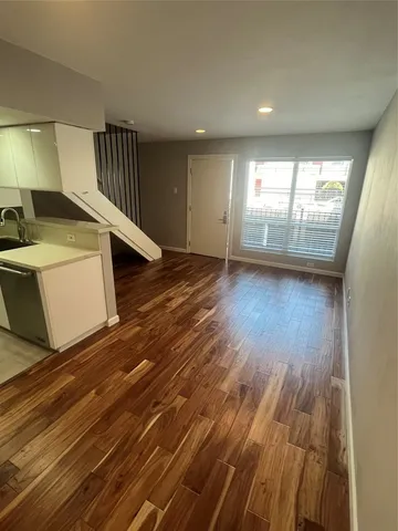 a view of a room with wooden floor and windows