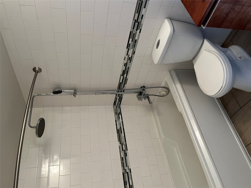 3110 Red River Street, Unit 216 Austin, TX 78705 - Photo 20 of 22 a white toilet sitting next to a bath tub