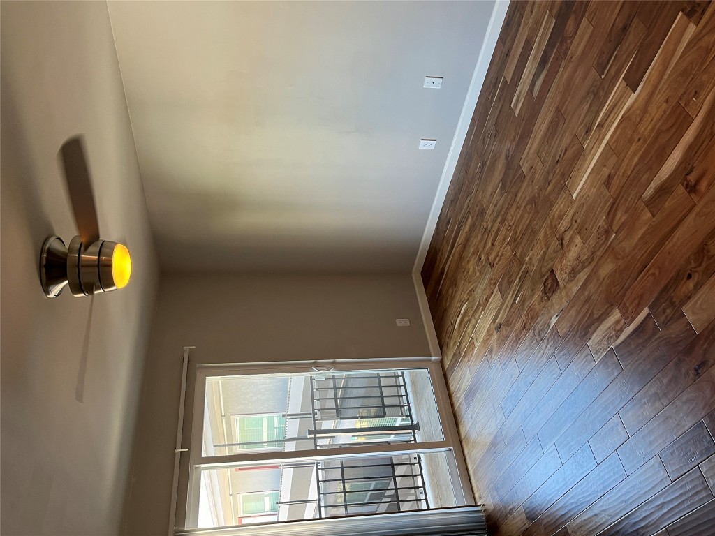 3110 Red River Street, Unit 216 Austin, TX 78705 - Photo 3 of 22 a view of an empty room with wooden floor and a window