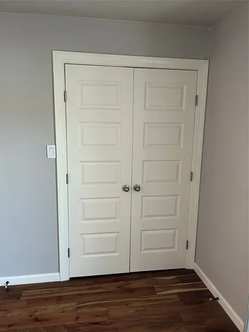 an empty room with wooden floor