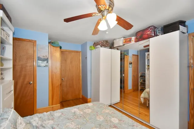 a view of a livingroom with a chandelier fan and refrigerator