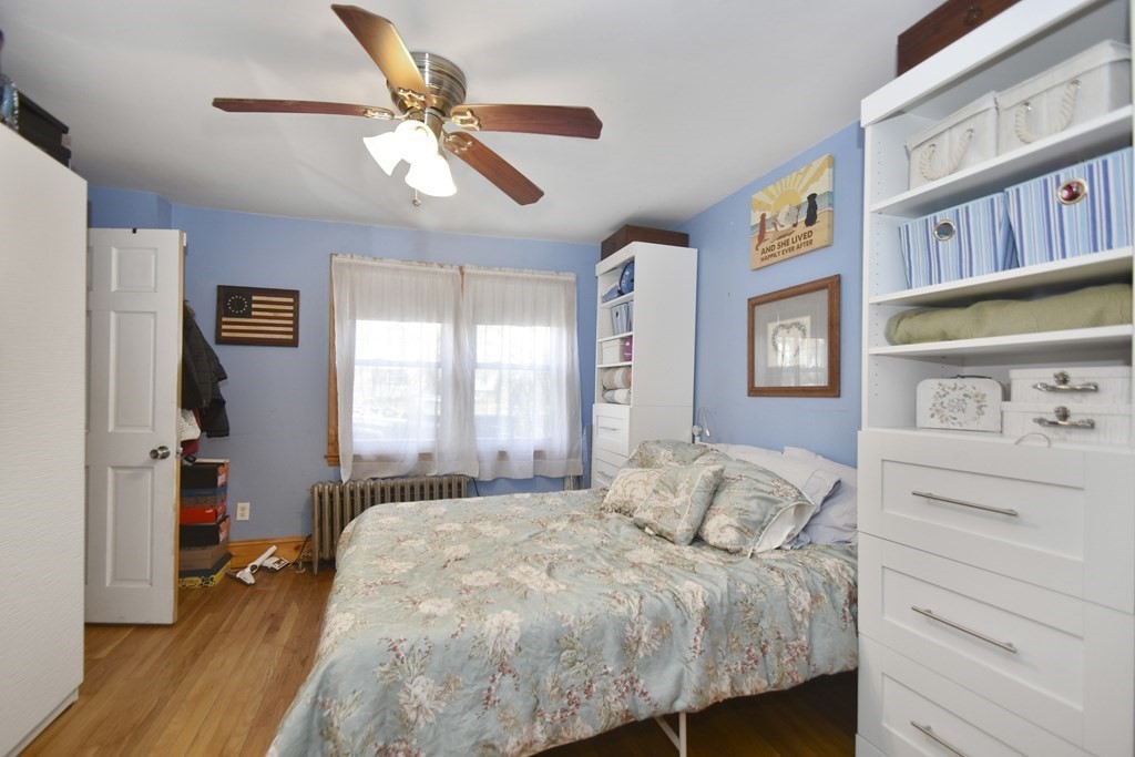 15 Madison Street Boston, MA 02136 - Photo 12 of 28 a bedroom with a bed and a book shelf