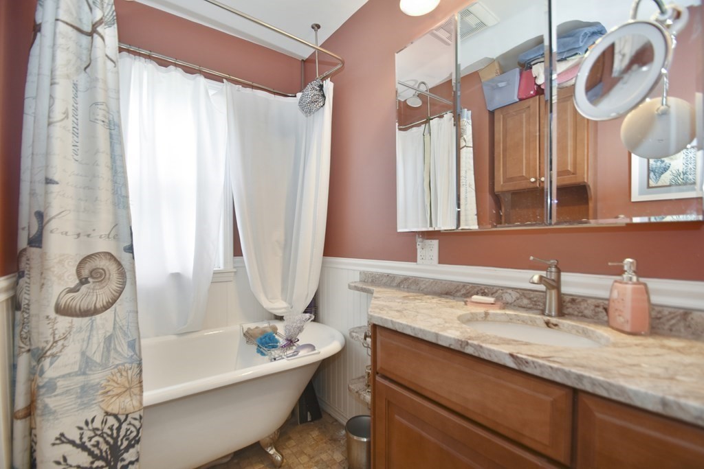15 Madison Street Boston, MA 02136 - Photo 19 of 28 a bathroom with a granite countertop sink and a mirror