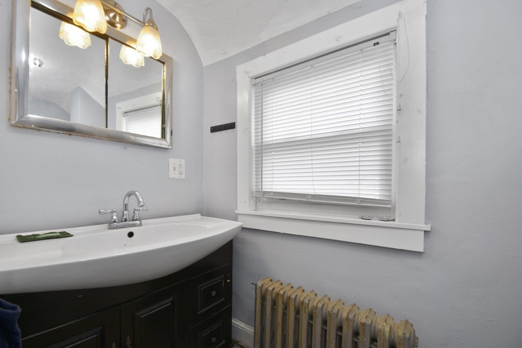 15 Madison Street Boston, MA 02136 - Photo 20 of 28 a bathroom with a sink a mirror and a window