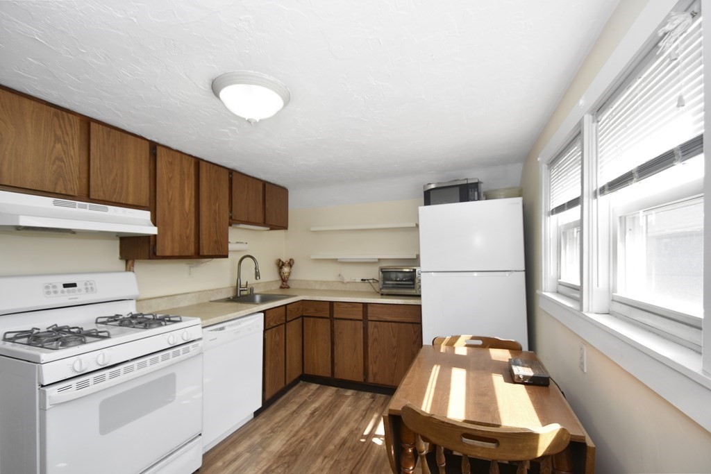 15 Madison Street Boston, MA 02136 - Photo 21 of 28 a kitchen with a sink a stove a refrigerator and cabinets