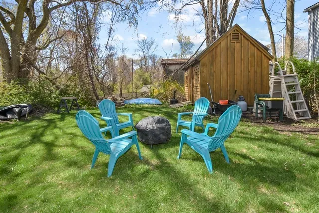 a view of a two chairs in the garden