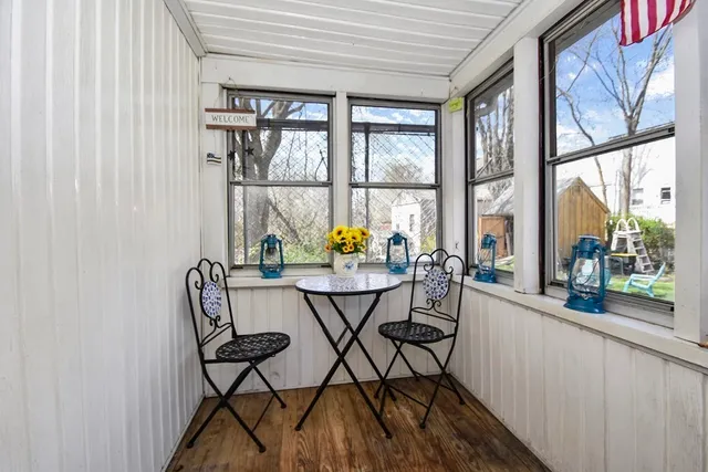 a view of a dining room with furniture and a window