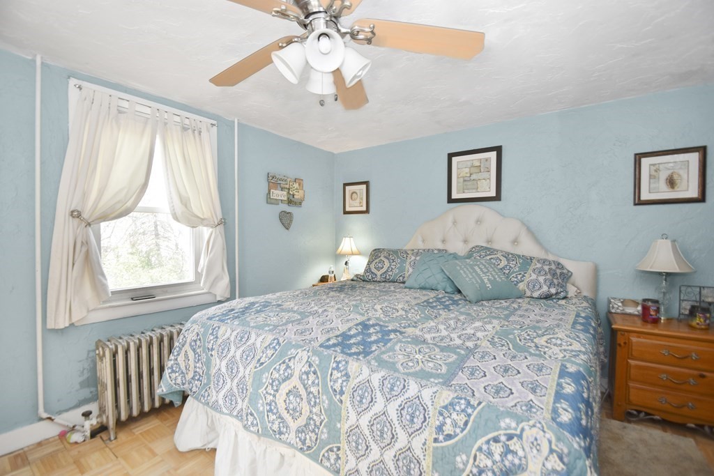 15 Madison Street Boston, MA 02136 - Photo 8 of 28 a bedroom with a large bed and a chandelier