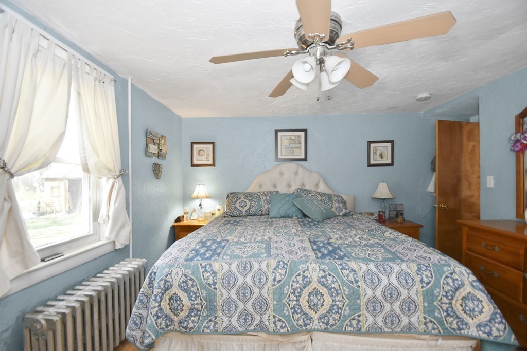 15 Madison Street Boston, MA 02136 - Photo 9 of 28 a bedroom with a large bed and a chandelier