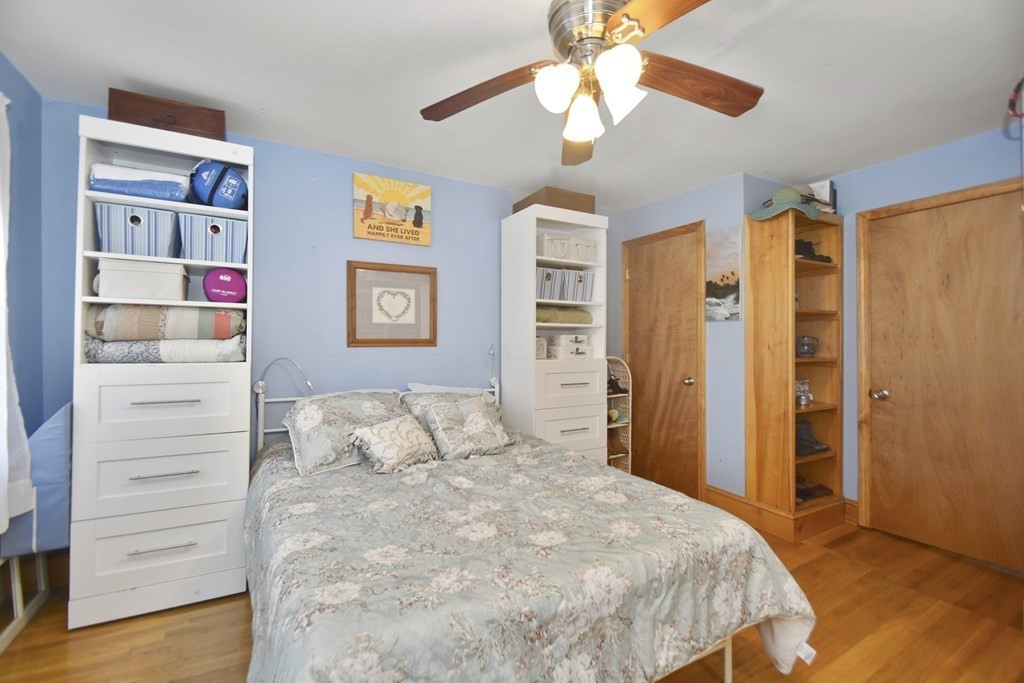 15 Madison Street Boston, MA 02136 - Photo 10 of 28 a bedroom with a bed and a chandelier