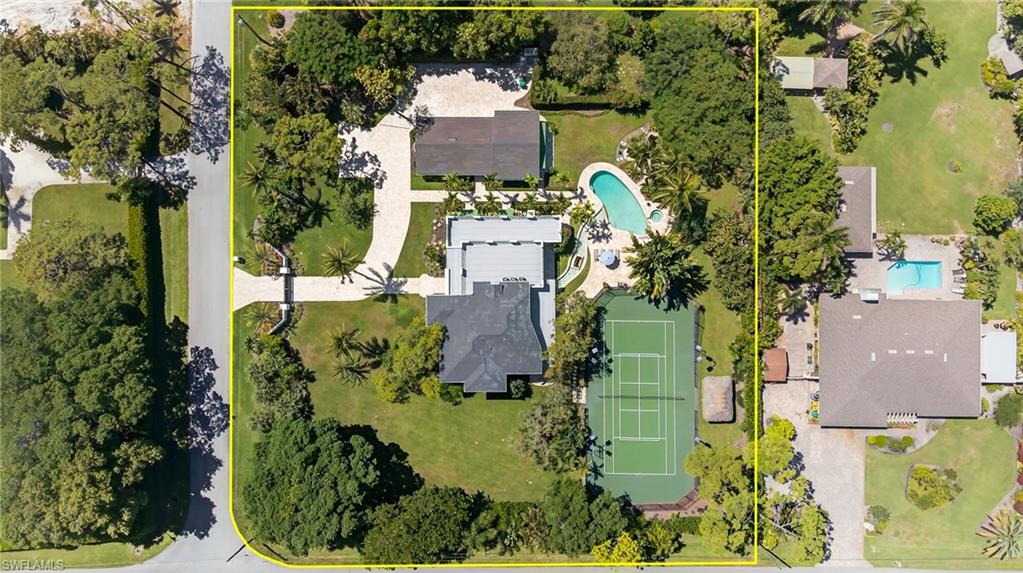 111 Caribbean Road Naples, FL 34108 - Photo 50 of 50 an aerial view of a house with a yard lake and trees all around