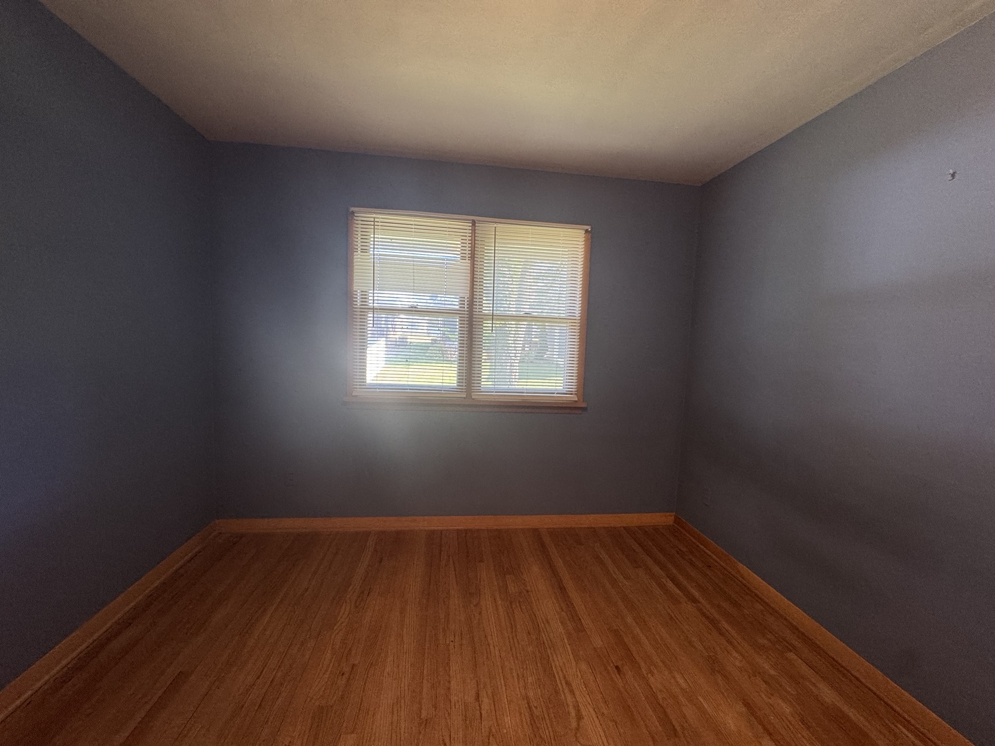 405 Prairie Court Streator, IL 61364 - Photo 12 of 16 an empty room with wooden floor and windows