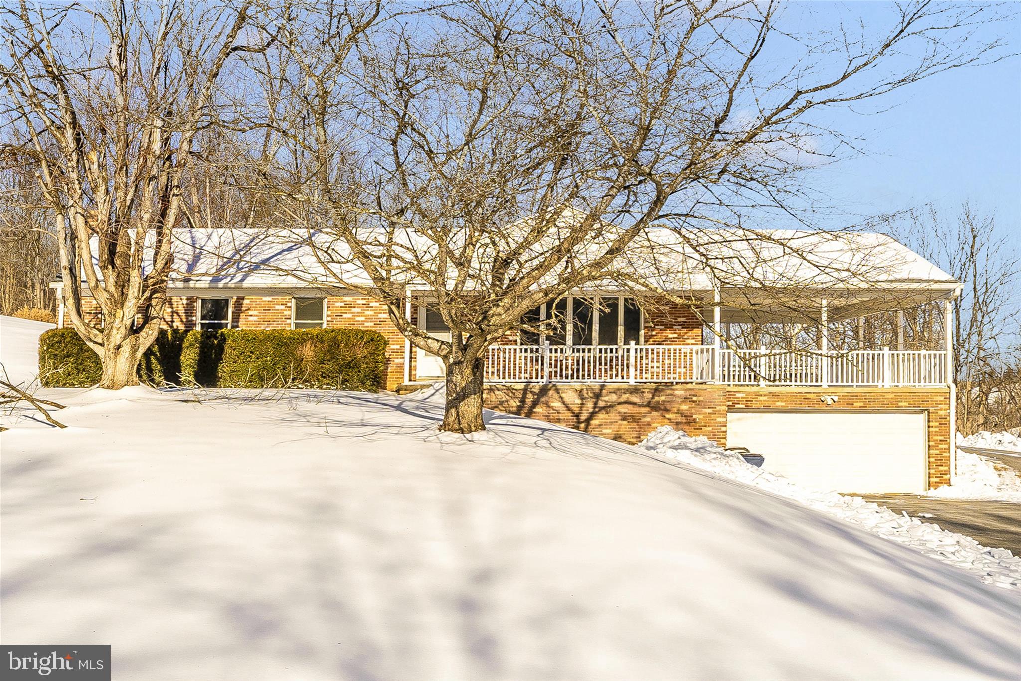 a view of a house with snow on the road