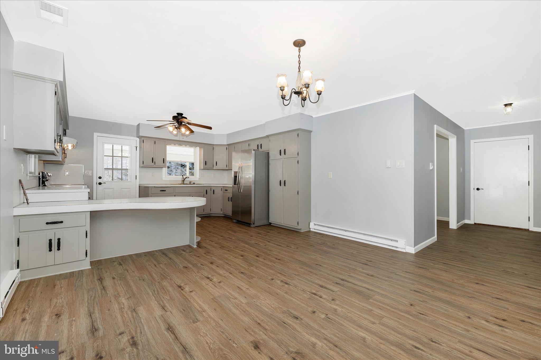 2640 Jefferson Pike Jefferson, MD 21755 - Photo 11 of 63 a view of a kitchen with a sink and dishwasher with wooden floor