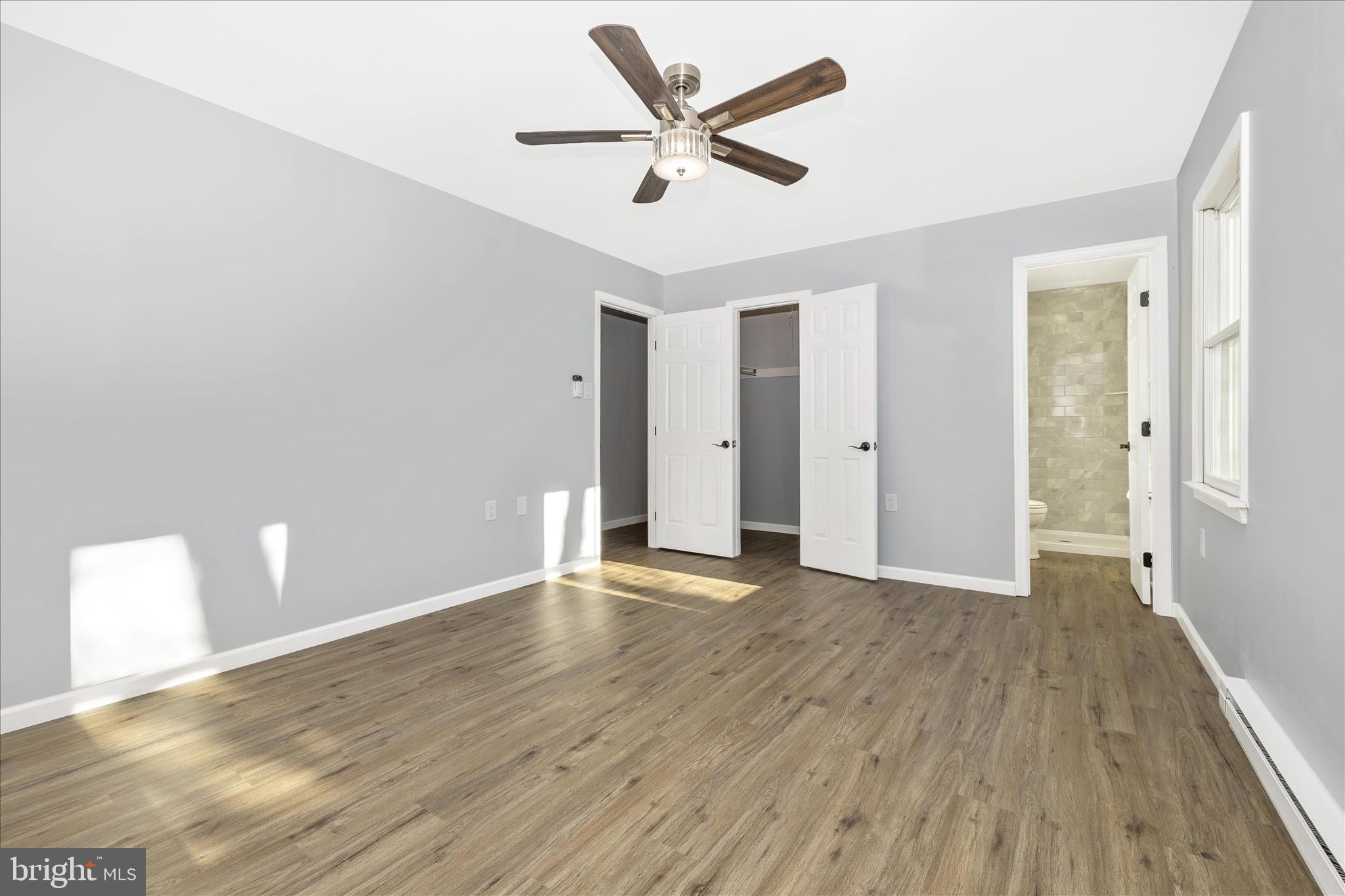 2640 Jefferson Pike Jefferson, MD 21755 - Photo 17 of 63 an empty room with wooden floor and a ceiling fan