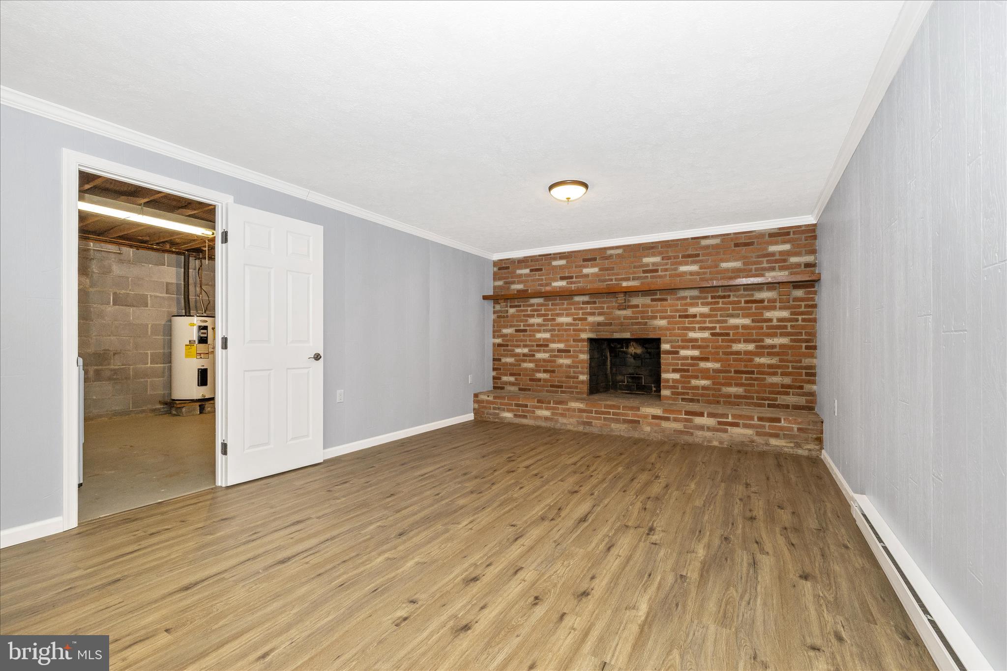 2640 Jefferson Pike Jefferson, MD 21755 - Photo 30 of 63 wooden floor in an empty room with a fireplace