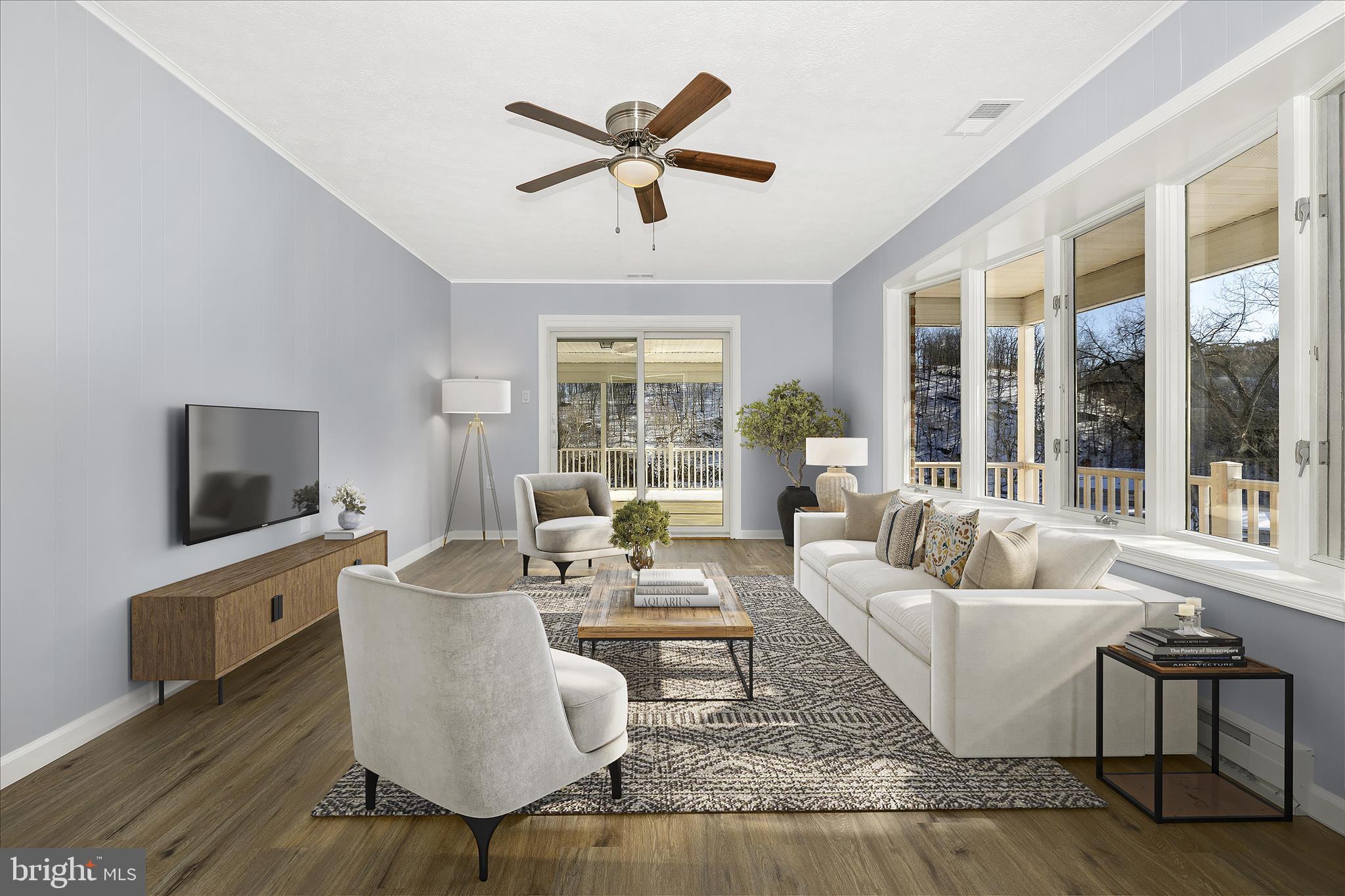 2640 Jefferson Pike Jefferson, MD 21755 - Photo 4 of 63 a living room with couches a coffee table and a flat screen tv with wooden floor