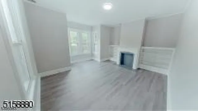 wooden floor in an empty room with a fireplace