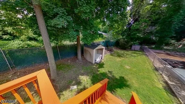 a view of a yard with plants and a lake view
