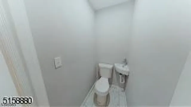 a white toilet sitting next to a shower