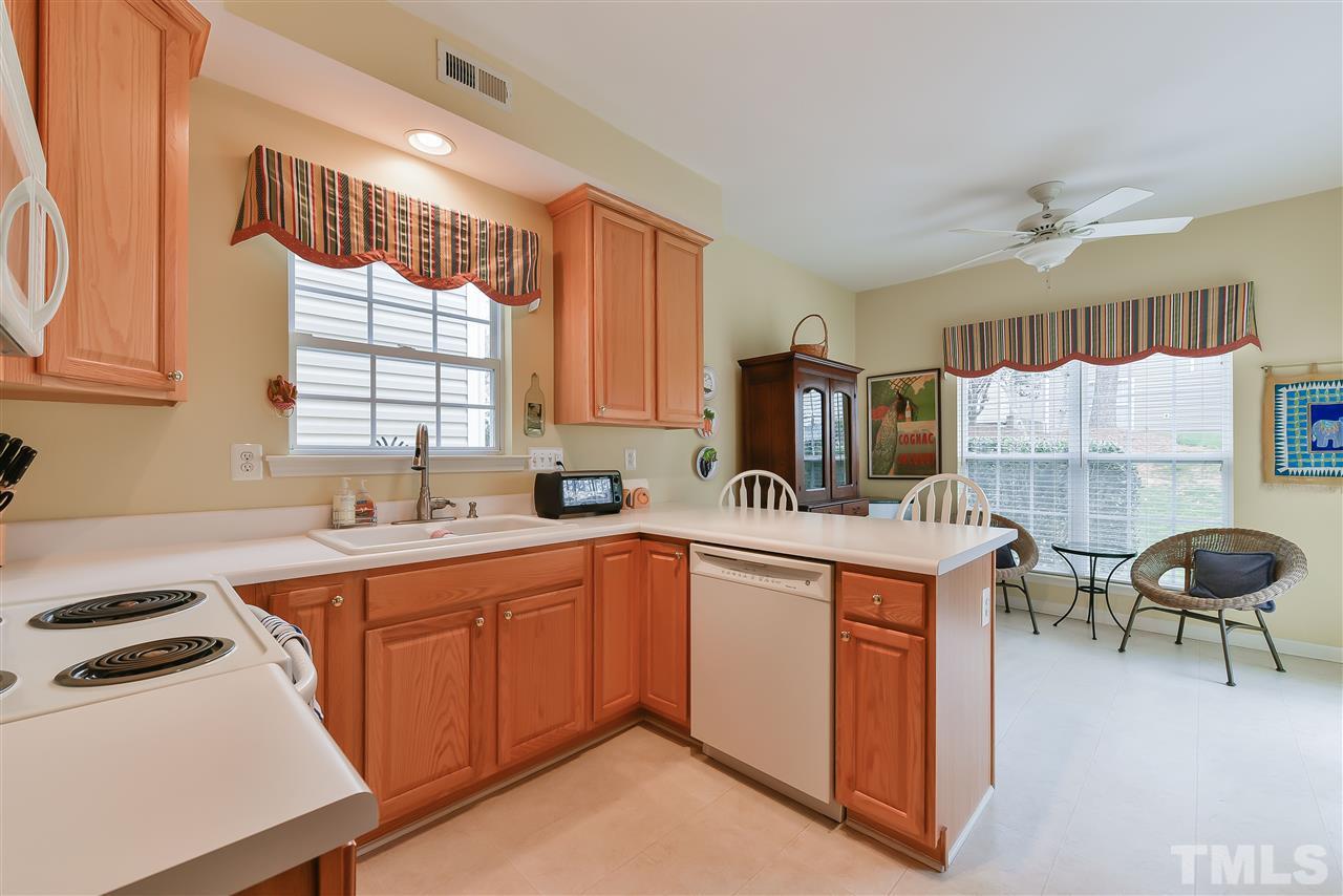5312 Eolian Court Raleigh, NC 27607 - Photo 4 of 9 a kitchen that has a sink a stove counter top space cabinets and a window