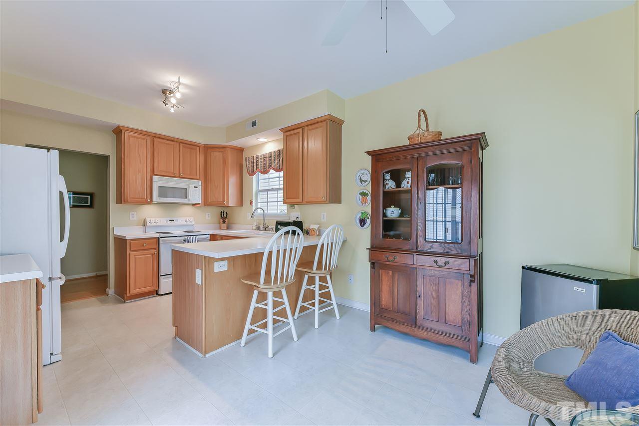 5312 Eolian Court Raleigh, NC 27607 - Photo 5 of 9 a kitchen with stainless steel appliances a refrigerator and wooden cabinets
