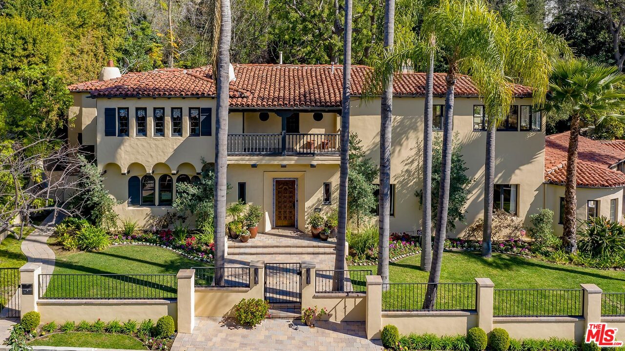 1130 Tower Road Beverly Hills, CA 90210 - Photo 2 of 30 a front view of a house with a garden and sitting area