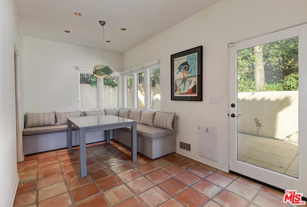 1130 Tower Road Beverly Hills, CA 90210 - Photo 11 of 30 a living room with furniture and large windows