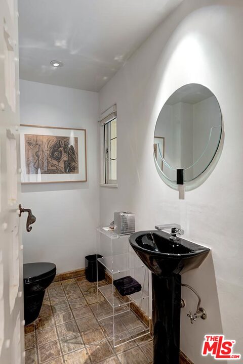 1130 Tower Road Beverly Hills, CA 90210 - Photo 15 of 30 a bathroom with a sink and a mirror