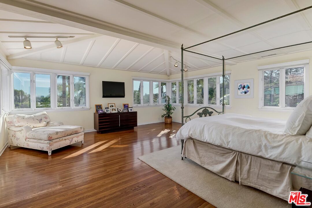 1130 Tower Road Beverly Hills, CA 90210 - Photo 16 of 30 a spacious bedroom with a bed and wooden floor