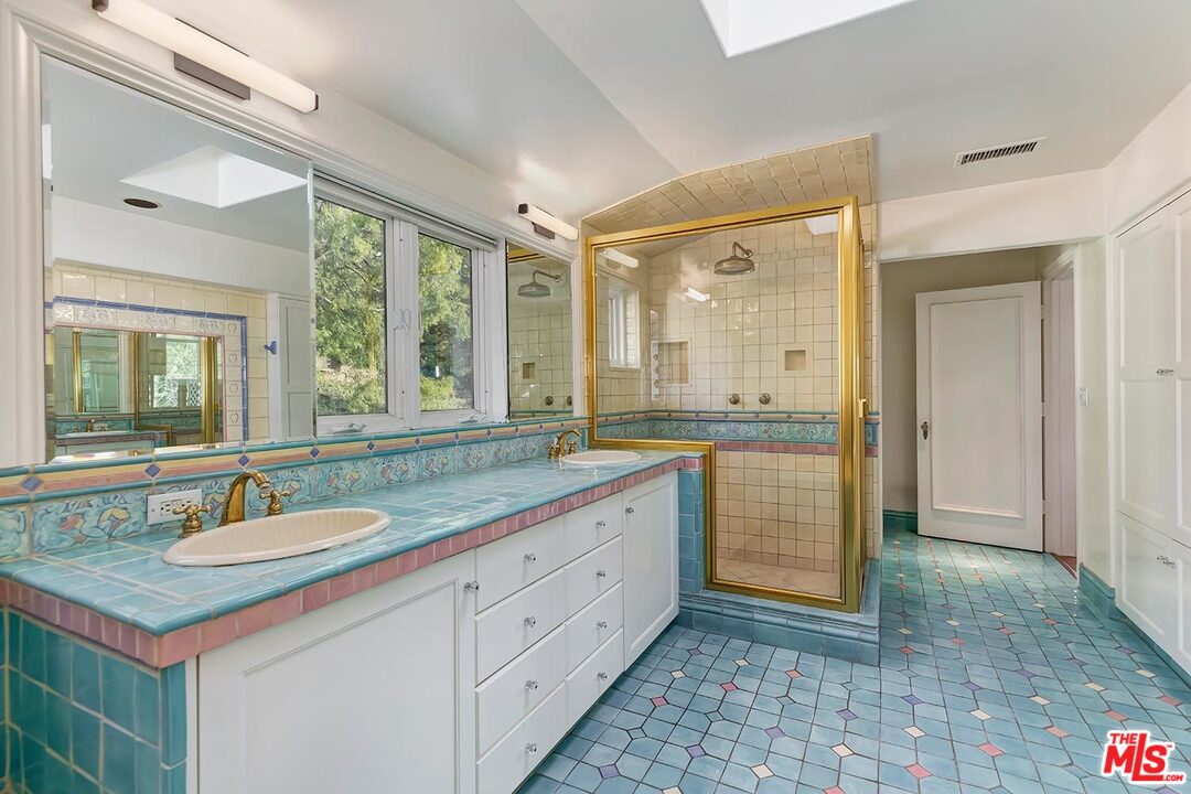 1130 Tower Road Beverly Hills, CA 90210 - Photo 18 of 30 a bathroom with a granite countertop sink mirror and a