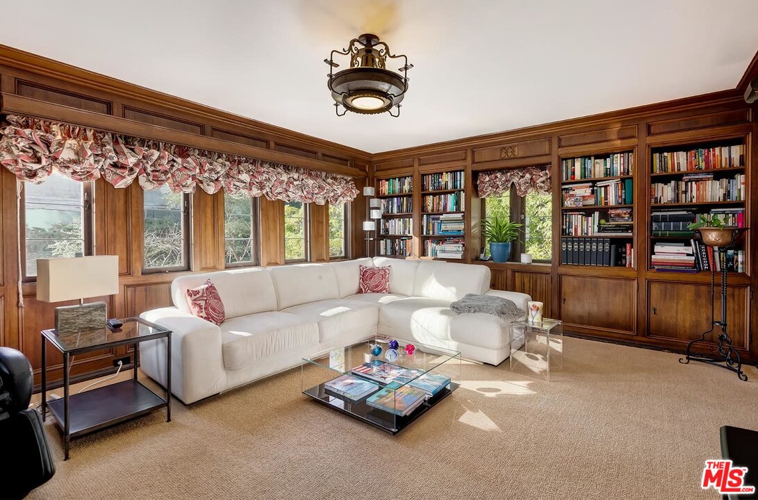 1130 Tower Road Beverly Hills, CA 90210 - Photo 20 of 30 a living room with furniture and a book shelf