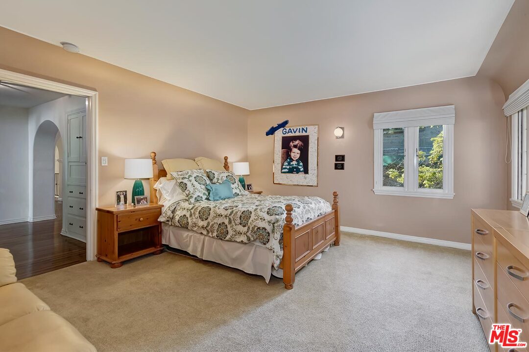 1130 Tower Road Beverly Hills, CA 90210 - Photo 22 of 30 a bedroom with a bed and a cabinets