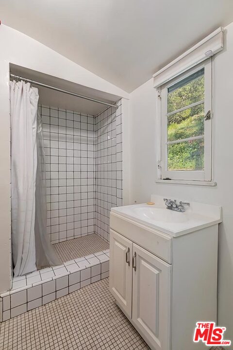 1130 Tower Road Beverly Hills, CA 90210 - Photo 27 of 30 a bathroom with a sink a toilet and shower