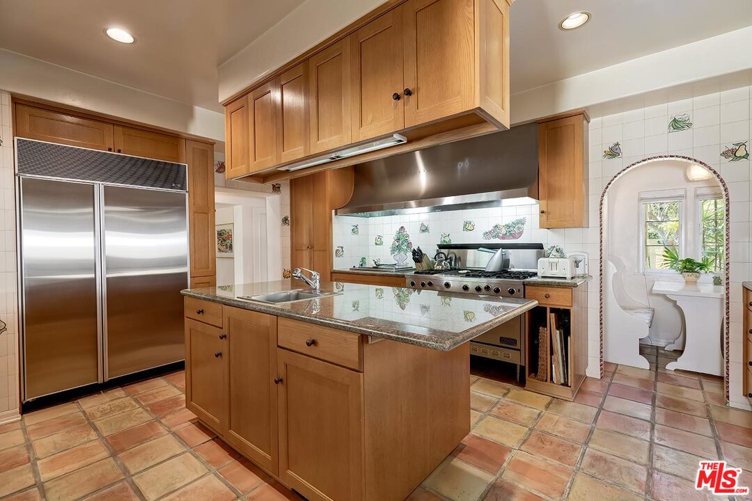 1130 Tower Road Beverly Hills, CA 90210 - Photo 10 of 30 a kitchen with cabinets and window