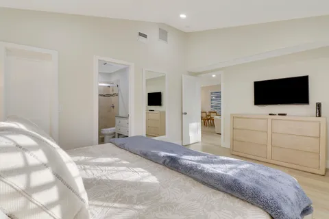 a bathroom with a granite countertop sink a toilet and shower