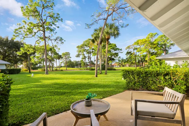 a view of a table and chairs in the garden