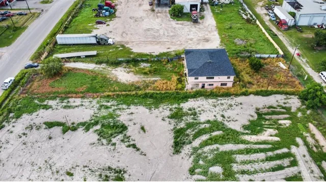 an aerial view of a house with a garden and lake view