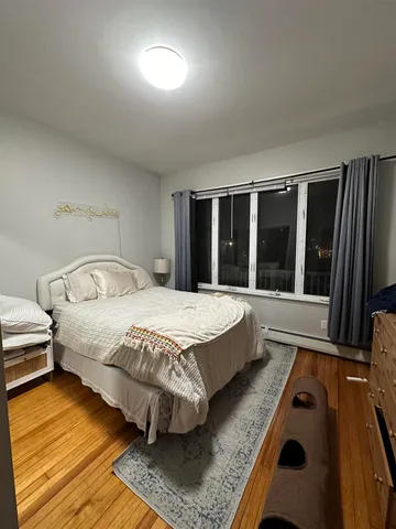 a bed sitting in a bedroom next to a window