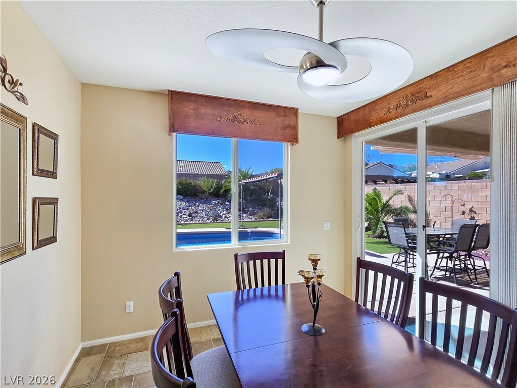 2485 Morrow Ridge Place Laughlin, NV 89029 - Photo 17 of 40 A well-lit dining area offers a seamless transition to the inviting outdoor living space and refreshing pool.