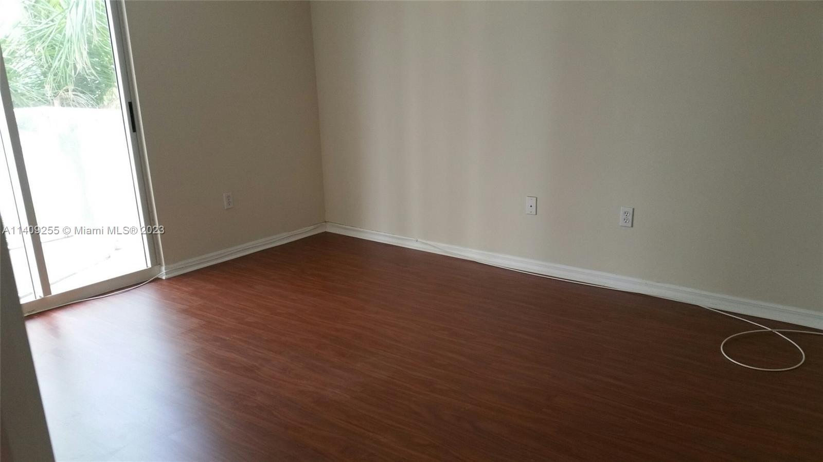 Miami Miami, FL 33126 - Photo 5 of 18 an empty room with wooden floor and windows
