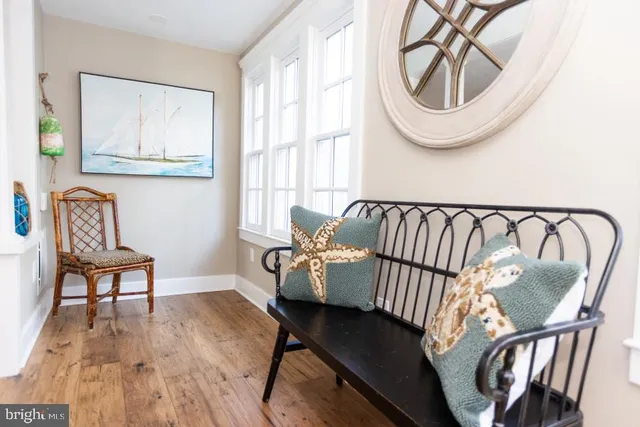 a view of entryway with furniture and wooden floor