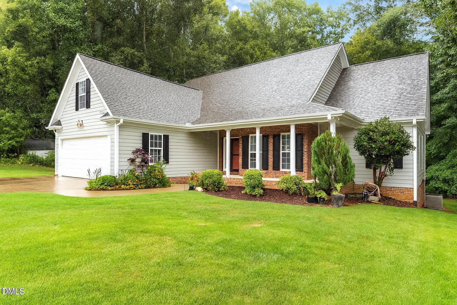 a view of a house with a yard and sitting area