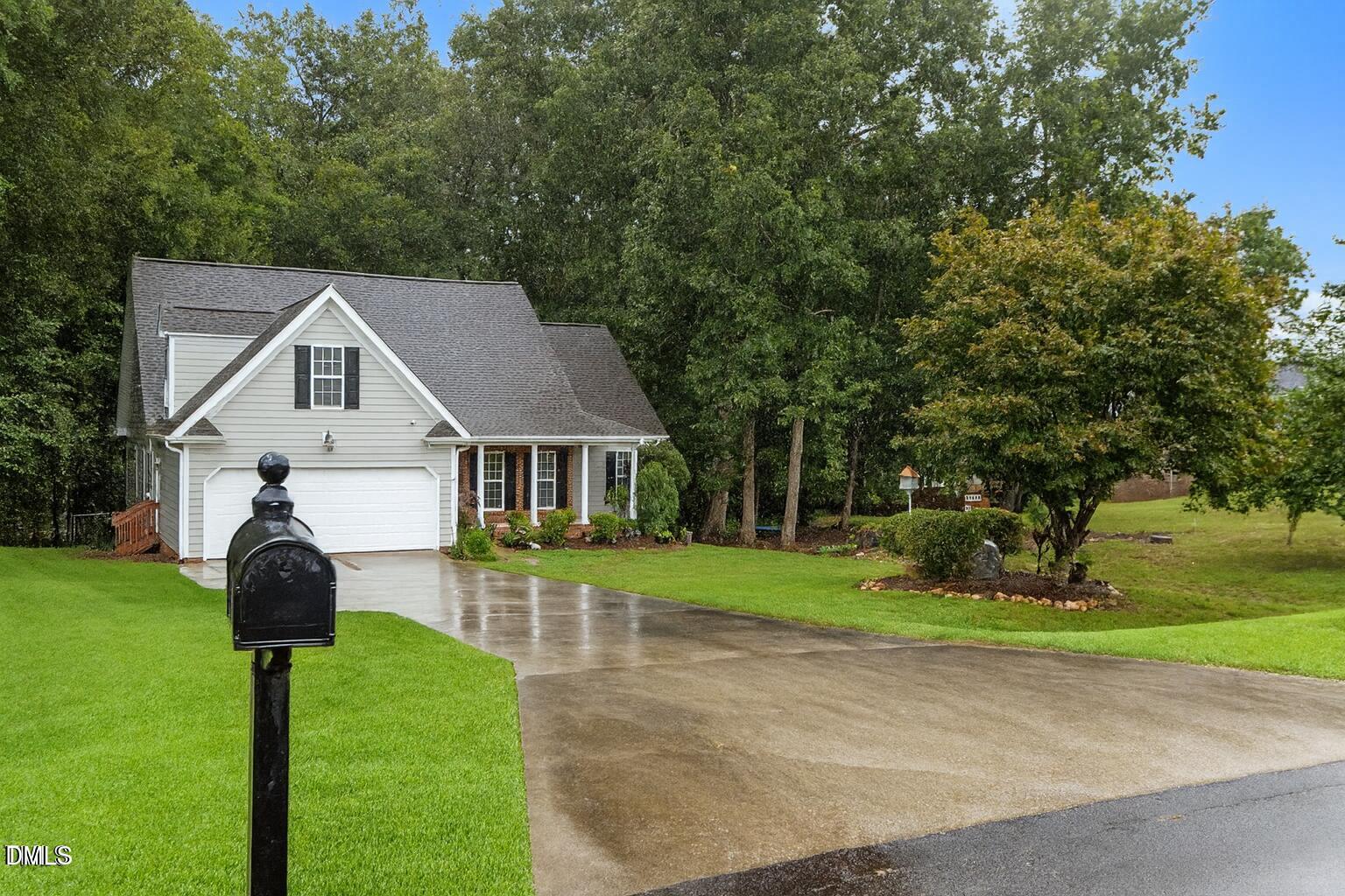 61 Fork Junction Road Timberlake, NC 27583 - Photo 6 of 59 a front view of a house with a yard table and porch