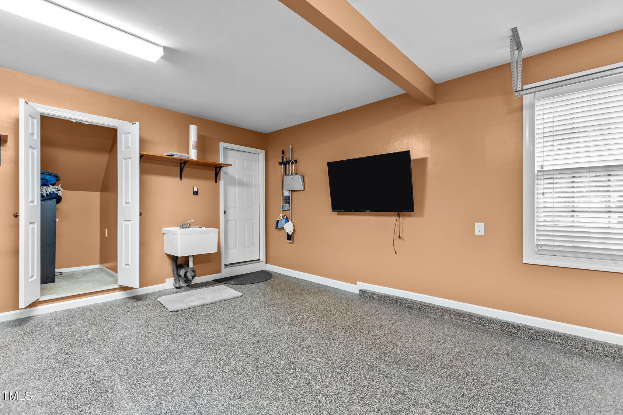 61 Fork Junction Road Timberlake, NC 27583 - Photo 39 of 59 a living room with a flat screen tv and gym equipment