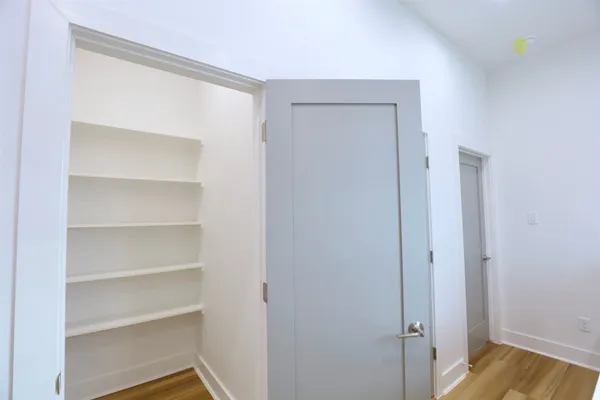 a view of walk in closet with empty racks