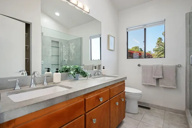 a bathroom with a double vanity sink and a mirror