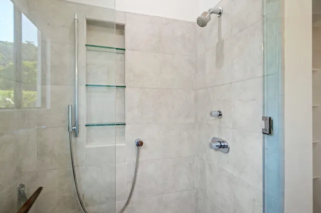 a bathroom with a glass shower door